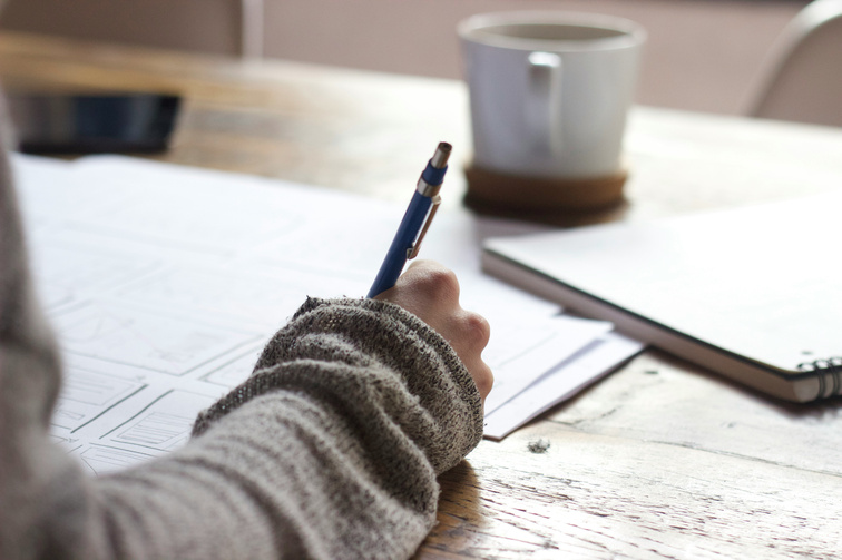 Photo of a person writing a list
